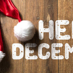 Hello December written on wooden background with Santa Hat Hello December written on wooden background with Santa Hat